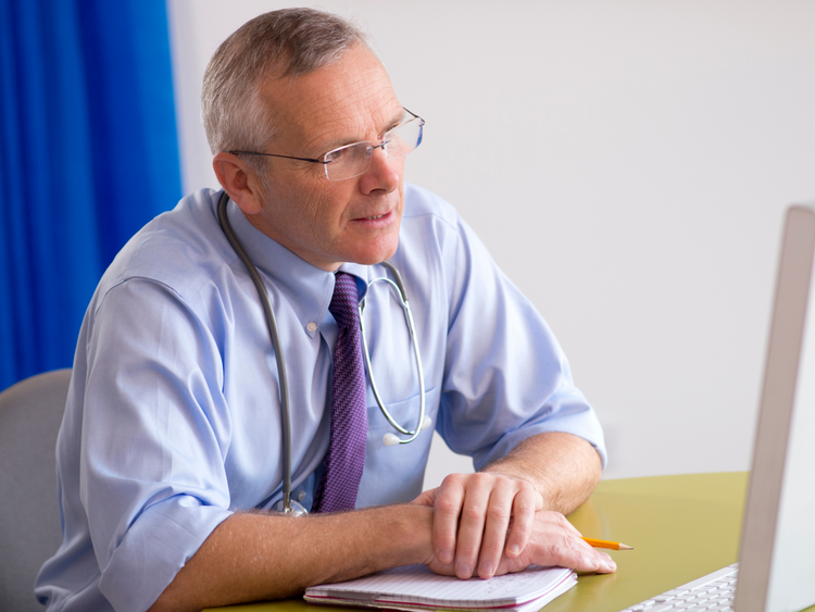 Doctor looking at a computer screen