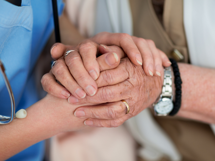 Nurse Holding a Person's Hand