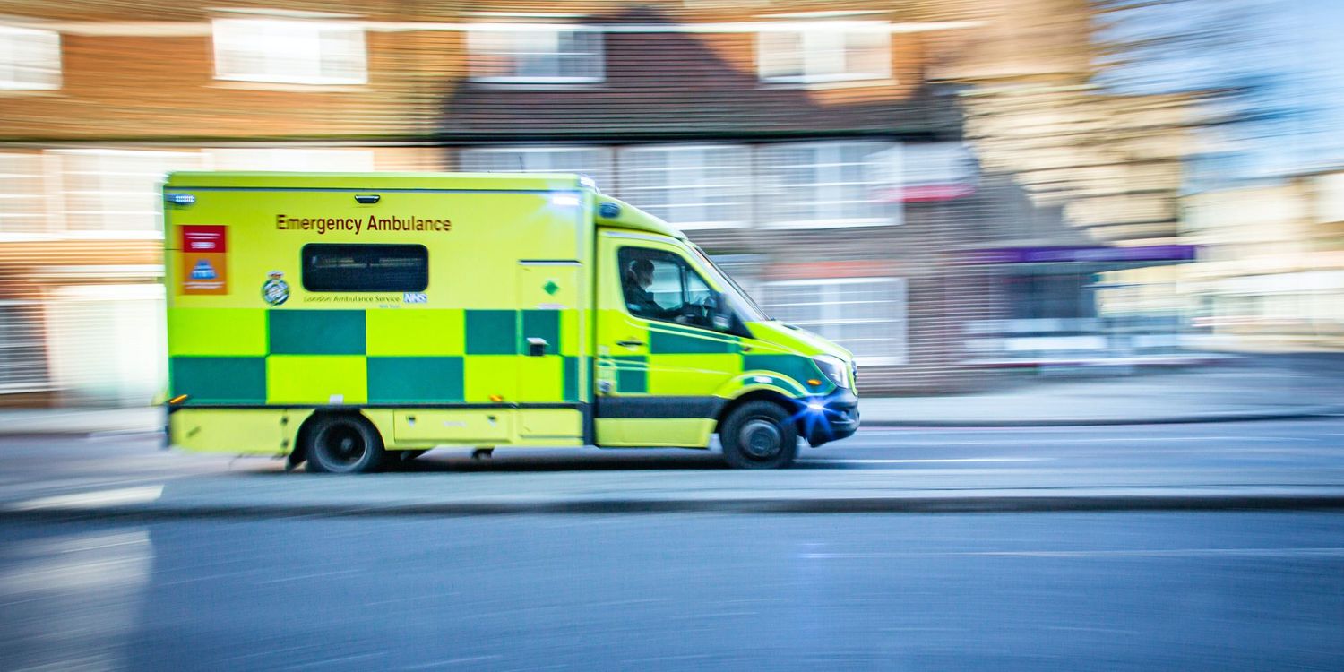 Ambulance driving down a street