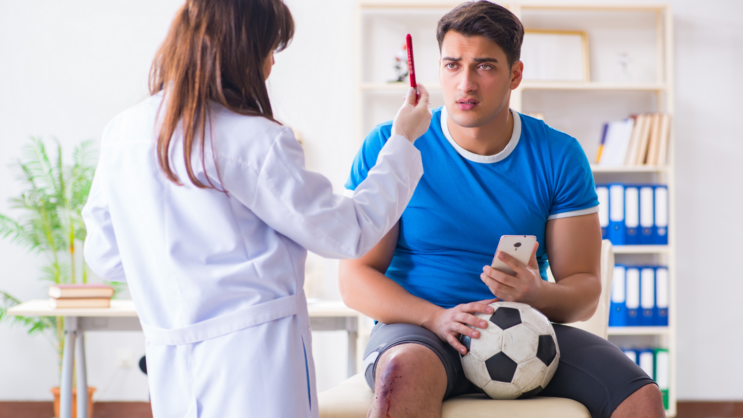 Football player undergoing medical tests with a Doctor