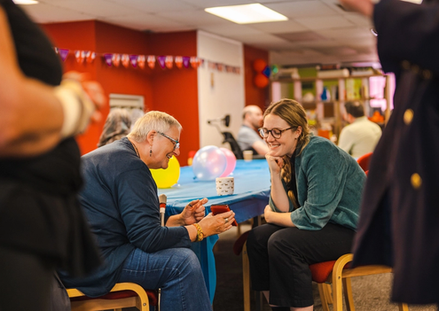 Two People Looking at a Phone at an Event