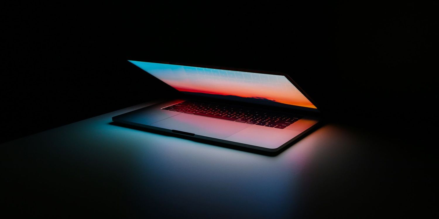 Laptop half open with a glowing screen