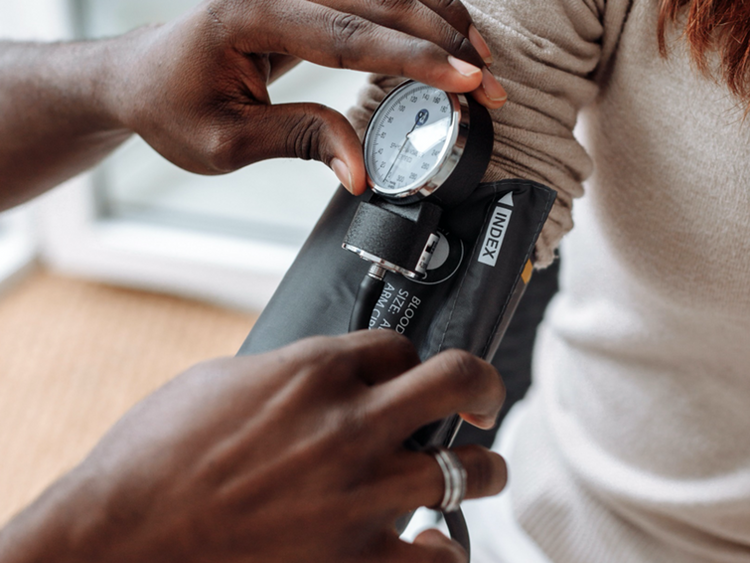 Person having their blood pressure measured with a device