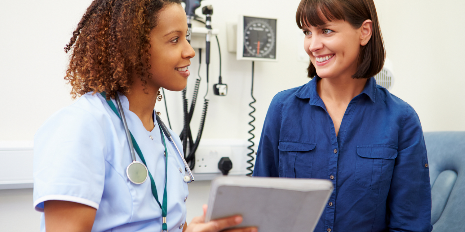 Nurse and Patient Looking at Notepad