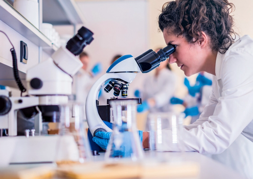 Doctor looking into a microscope