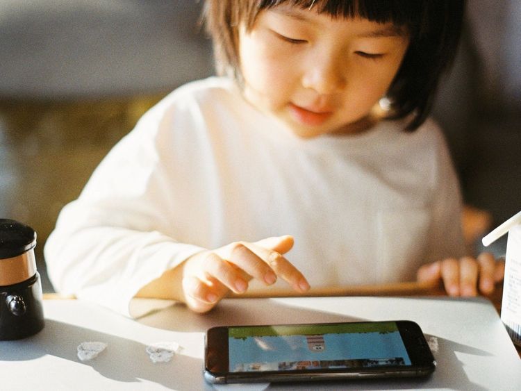 Child playing games on mobile phone