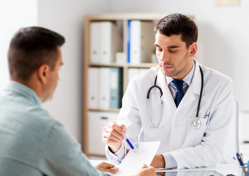 A Doctor and a patient looking over some notes