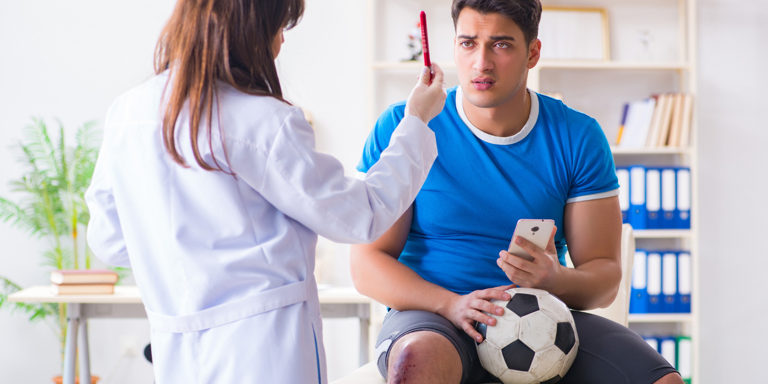 Football player undergoing medical tests with a Doctor