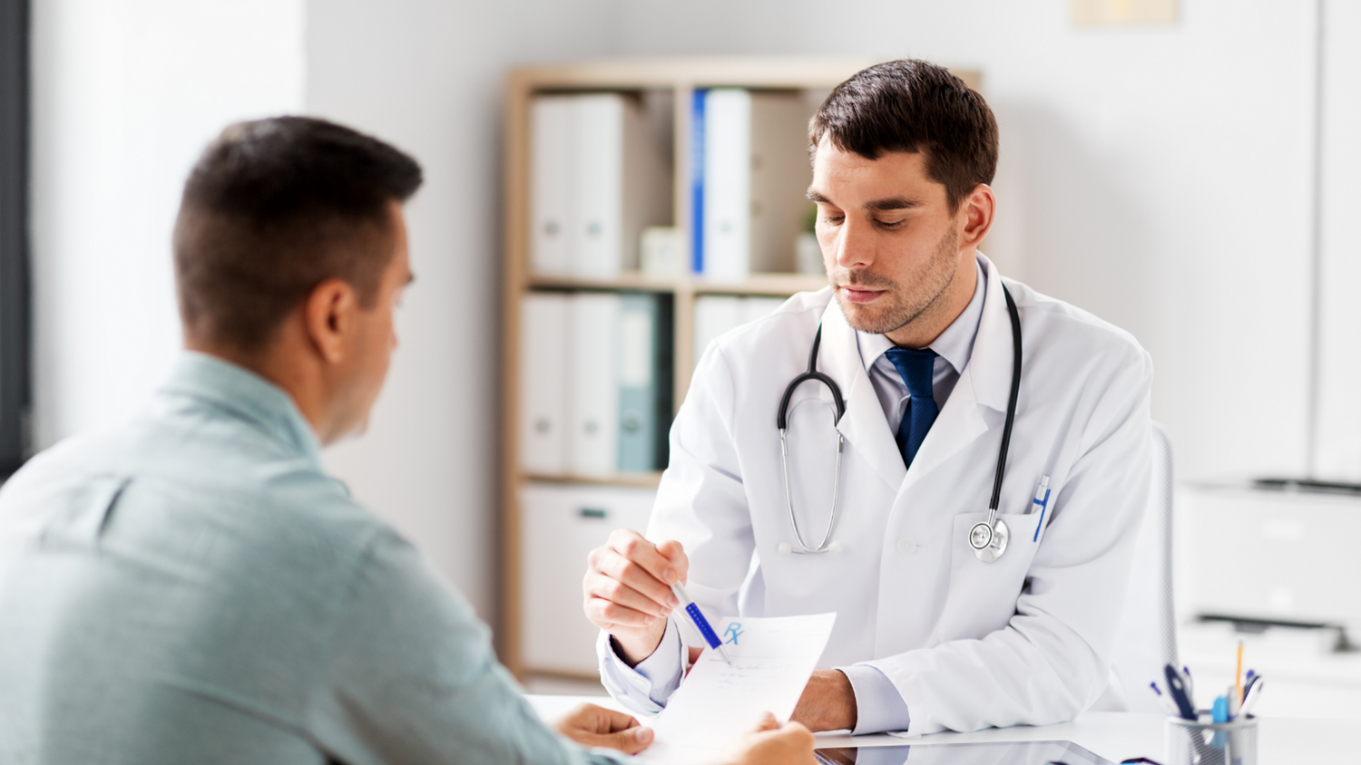 A Doctor and a patient looking over some notes