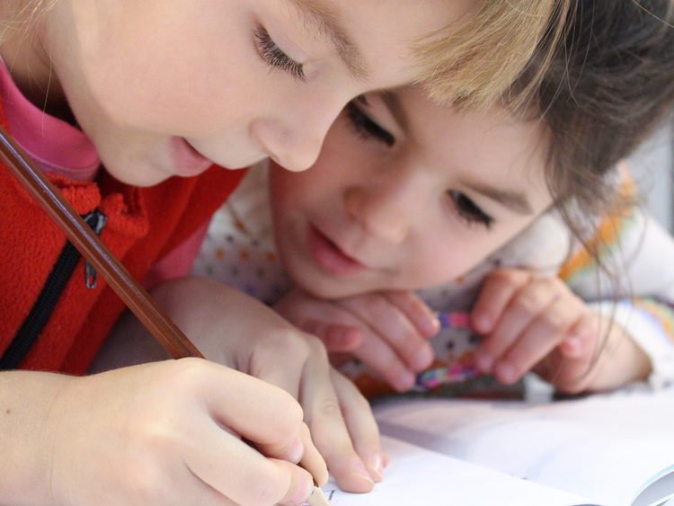 Children writing in a notebook