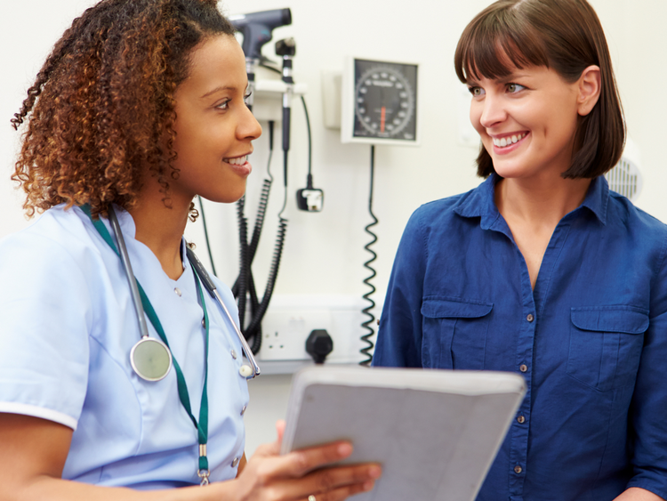 Nurse and Patient Looking at Notepad