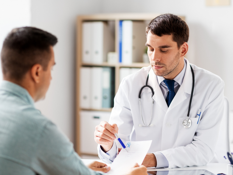 A Doctor and a patient looking over some notes