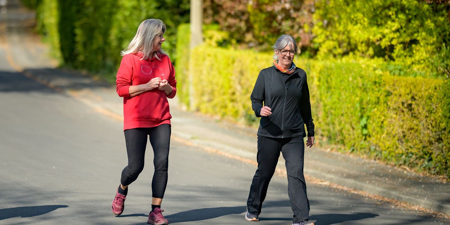 Two people walking down a street